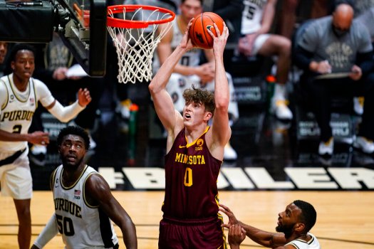 Minnesota center Liam Robbins (0) goes up for a dunk over Purdue forward Trevion Williams (50) during the first half of an NCAA college basketball game in West Lafayette, Ind., Saturday, Jan. 30, 2021. (AP Photo/Michael Conroy)