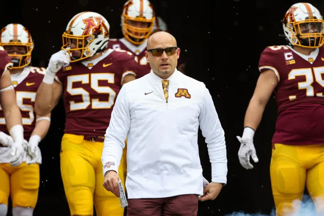 Nov 12, 2022; Minneapolis, Minnesota, USA; Minnesota Golden Gophers head coach P.J. Fleck leads his team out onto the field before the game against the Northwestern Wildcats at Huntington Bank Stadium. Mandatory Credit: Matt Krohn-USA TODAY Sports