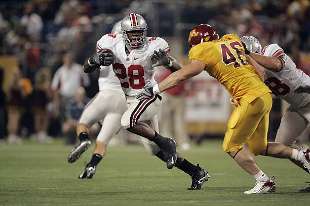 chris-wells-of-the-ohio-state-buckeyes-runs-the-ball-against-john-of-picture-id80472654