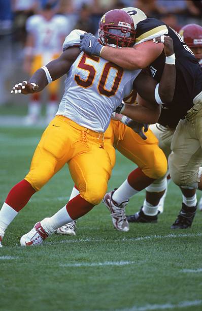 sep-2000-greg-white-of-the-minnesota-golden-gophers-is-held-back-the-picture-id718610